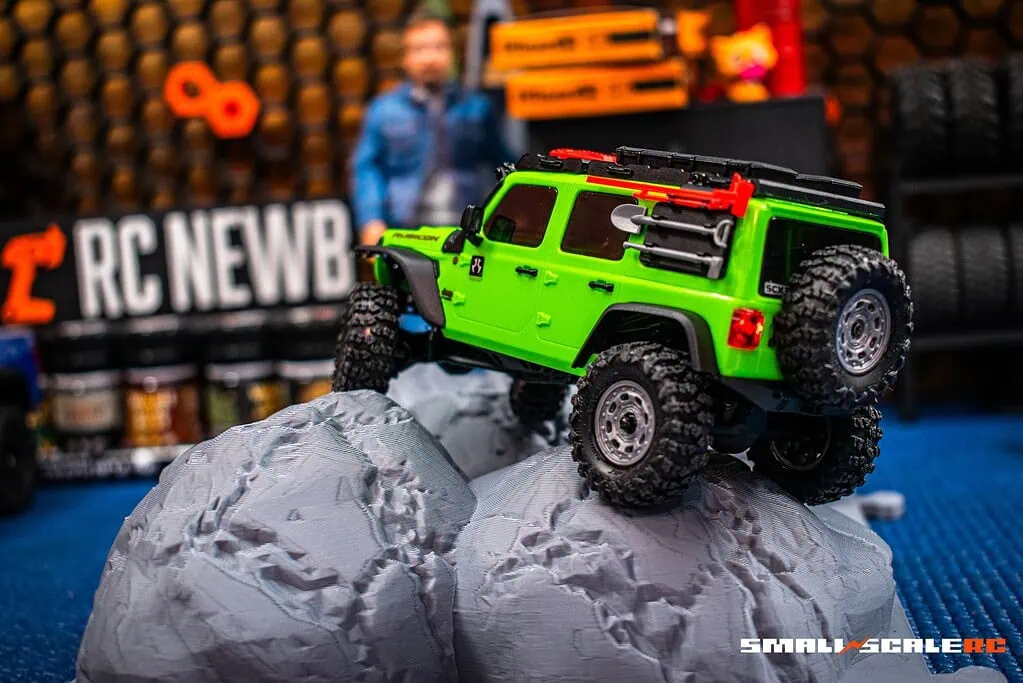 RC off-road vehicle climbing rocky terrain for scale model enthusiasts.