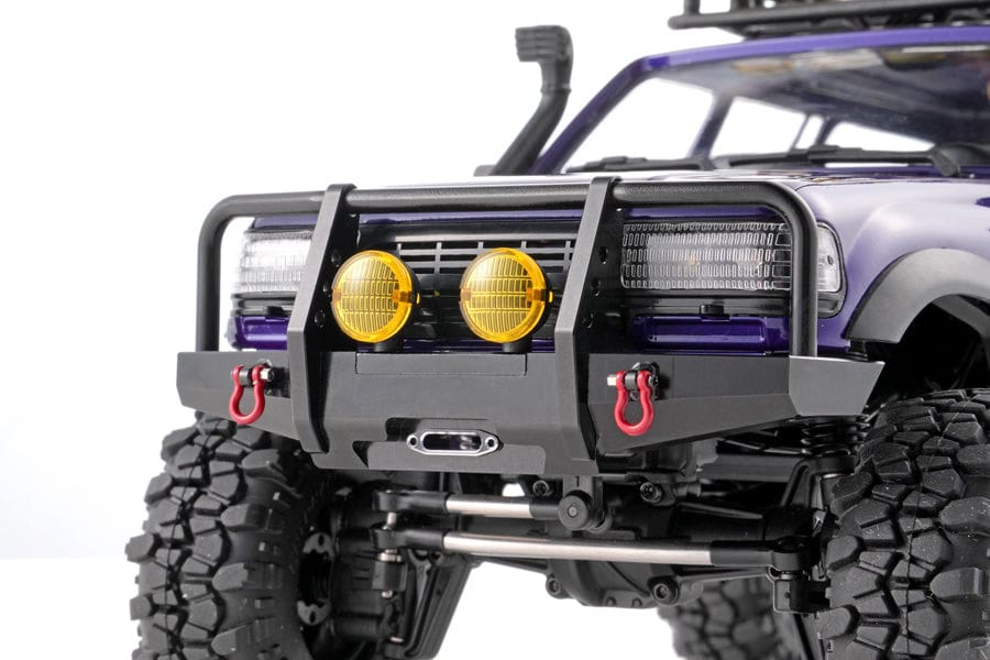 RC off-road truck with rugged tires and front bumper accessories.