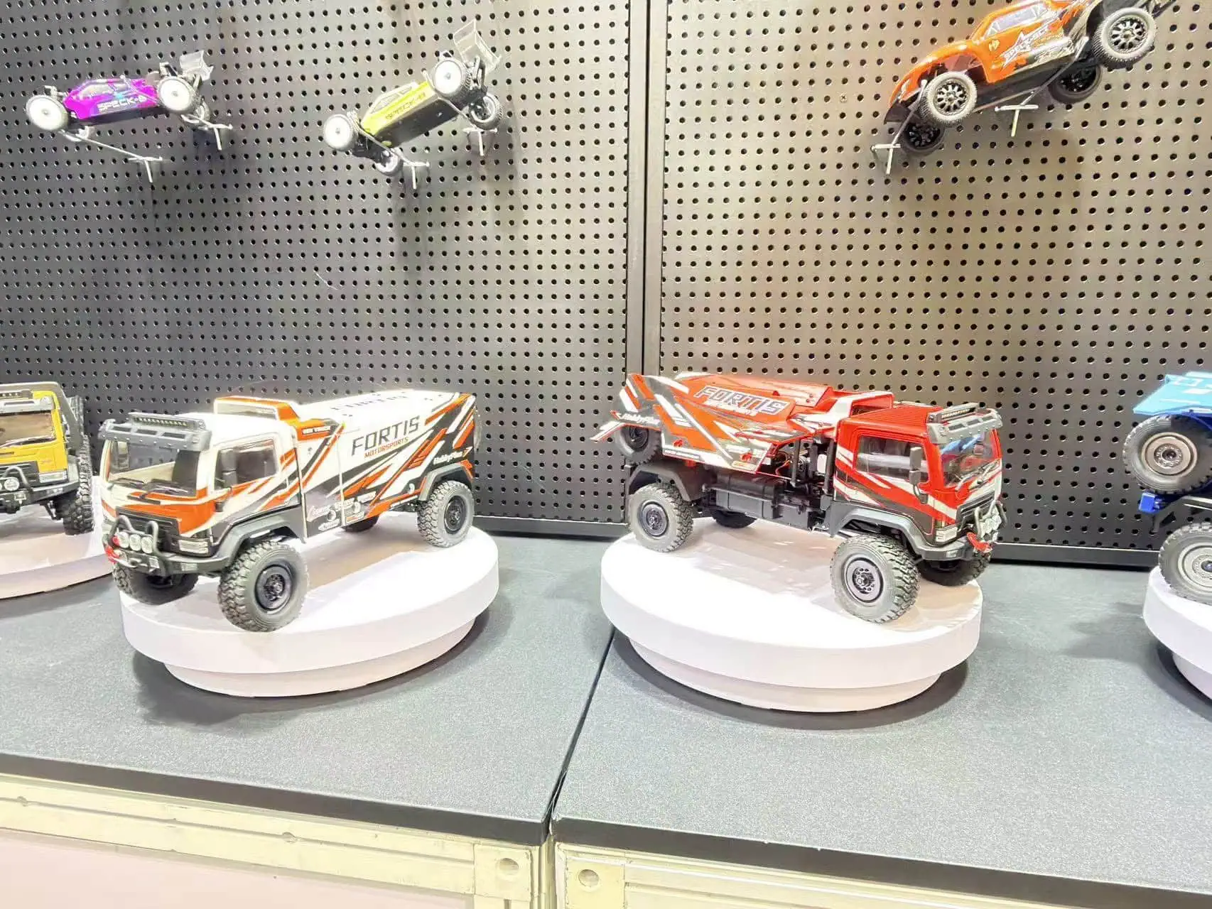 Detailed view of 1/18 scale Fortis DKR4 RC trucks on display at the Shanghai International Toys and.