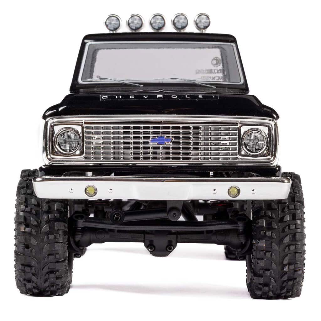 Chevrolet-themed small-scale RC truck with off-road tires and LED light bar.