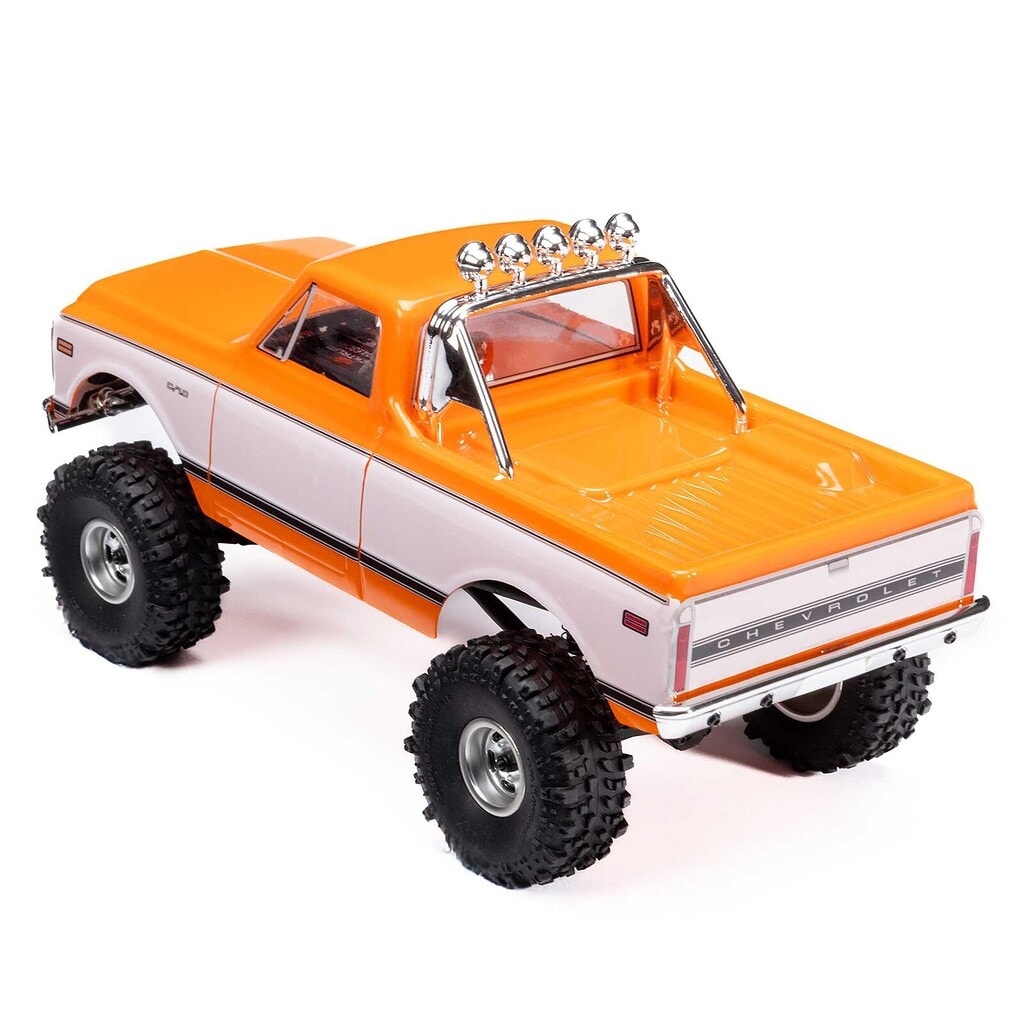 Bright orange and white small-scale RC off-road truck with rugged tires and detailed design.