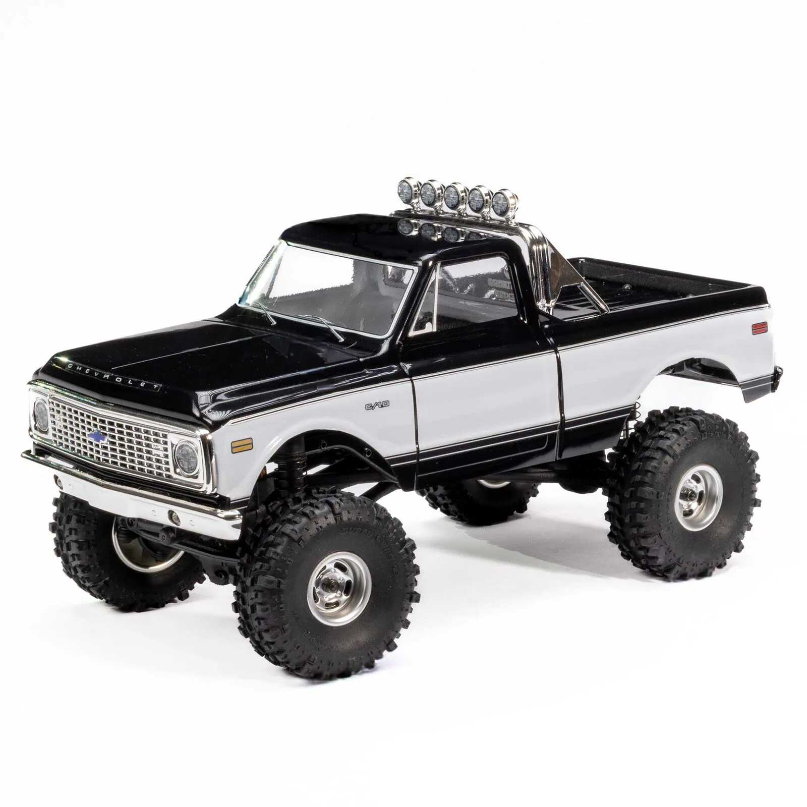 Remote control off-road truck with large tires and LED light bar for RC enthusiasts.