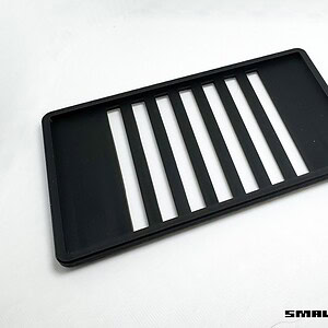 Miniature black plastic grill for small-scale remote control vehicles, ideal for custom RC car modif.