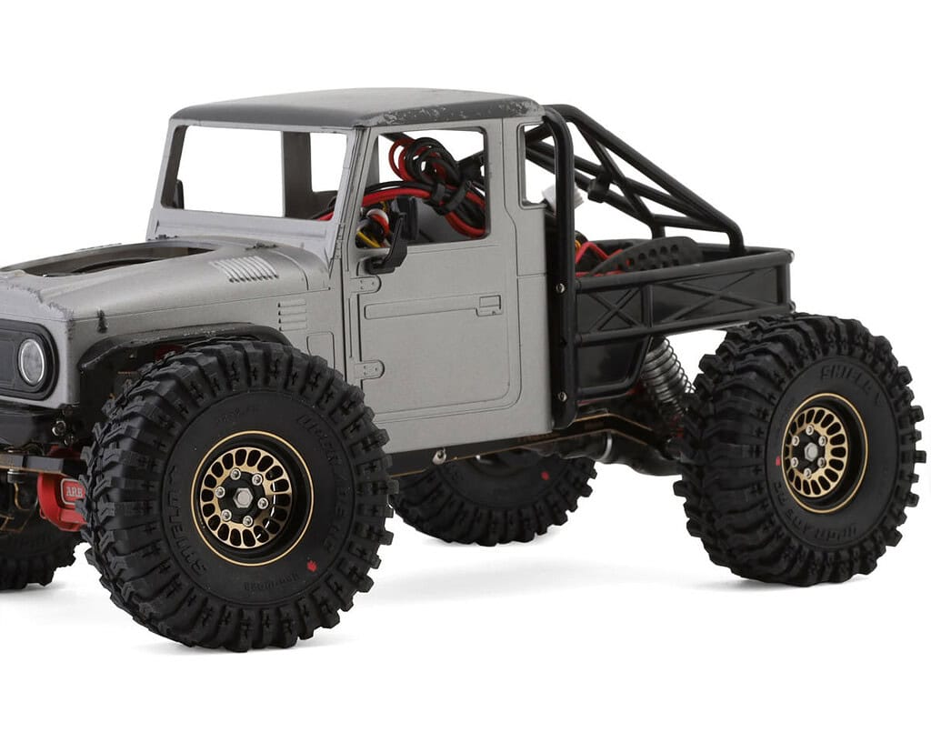 High-performance small-scale RC off-road truck with rugged tires and durable chassis for outdoor adv.